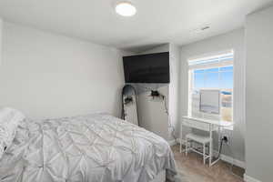 Bedroom featuring light colored carpet and baseboards