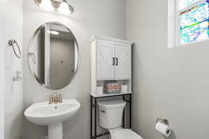 Half bath with toilet and a sink