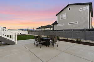 Fenced backyard featuring a patio and a fire pit