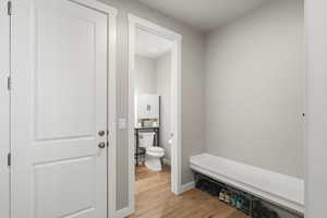 Mudroom featuring light wood-type flooring and baseboards