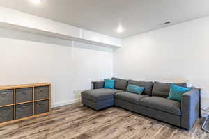 Living area with wood finished floors and baseboards