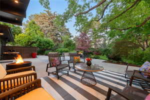 View of patio / terrace featuring area for grilling and an outdoor living space with a fire pit
