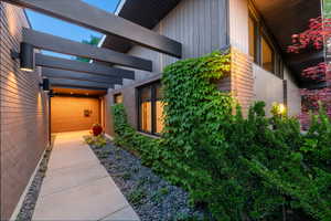 View of side of home with brick siding and board and batten siding