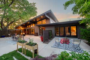 Rear view of property with outdoor dining area and a patio