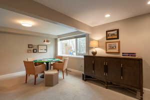 Game room with light carpet and baseboards