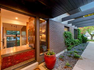Doorway to property with brick siding