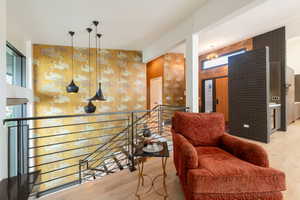 Sitting room featuring light wood-style floors and an upstairs landing