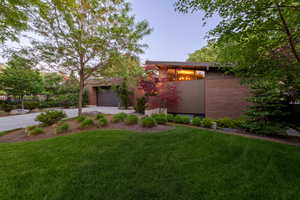 View of front of home featuring concrete driveway and an attached garage