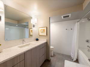 Bathroom with vanity, tile walls, and shower / bath combo