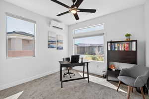Office with light carpet and a ceiling fan