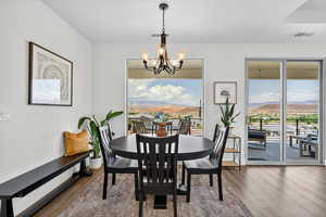 Dining room featuring a mountain view, a chandelier, and wood finished floors