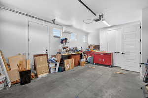 Garage featuring a mini split for heating / cooling and a garage door opener