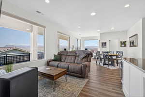 Living room featuring dark wood-style flooring and recessed lighting