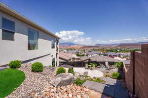 Fenced backyard featuring a patio area, a residential view, and a mountain view