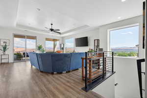 Living area with a mountain view, wood finished floors, and healthy amount of natural light