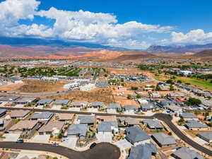 Aerial perspective of suburban area with a mountainous background