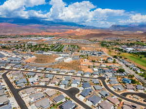 Aerial perspective of suburban area featuring a mountainous background