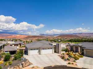 Prairie-style house featuring an attached garage, driveway, stucco siding, and a mountain view
