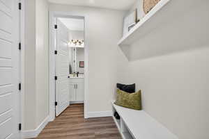 Mudroom featuring wood finished floors and baseboards