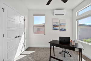 Home office with carpet flooring and ceiling fan
