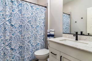 Bathroom with vanity and curtained shower
