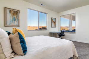 Bedroom featuring carpet and baseboards