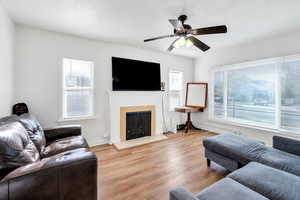 Large living room has fireplace and lots of natural light