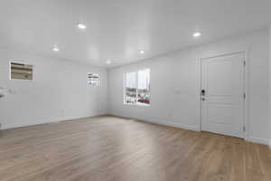 Entryway featuring light wood finished floors and recessed lighting