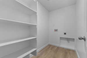 Laundry room featuring washer hookup, light wood-style floors, and hookup for an electric dryer