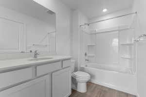 Full bath with vanity, light wood-style floors, and tub / shower combination