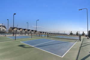 View of tennis court featuring a residential view