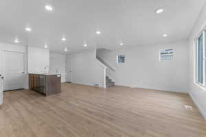 Unfurnished living room featuring recessed lighting and light wood-type flooring