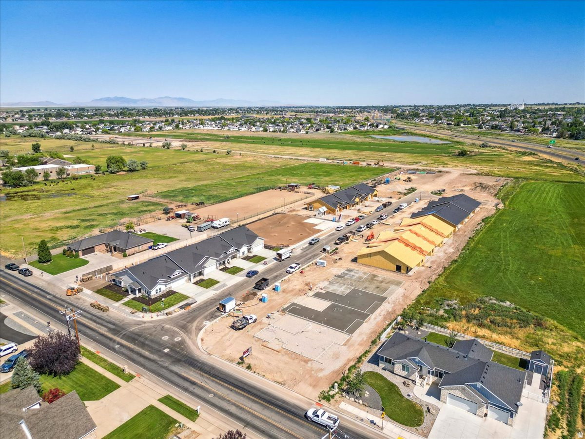 Newly developed residential area featuring multiple single-family residences and townhomes, some completed and others under construction