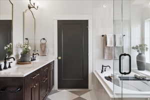 Dual vanity with dark wood cabinetry, white countertop, and matte black fixtures