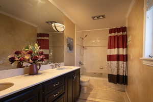 Bathroom with double vanity, shower/ tub combo