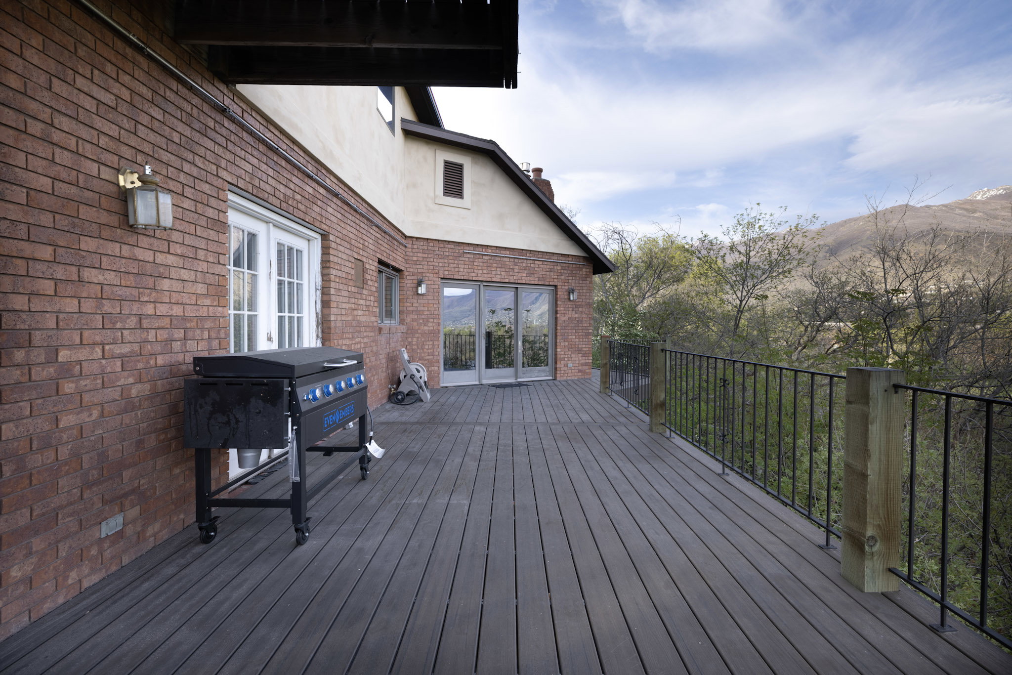Wooden terrace featuring area for grilling and a mountain view