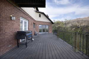 Wooden terrace featuring area for grilling and a mountain view