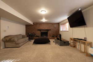Basement family room featuring a fireplace and brick wall