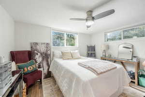 Bedroom with wood finished floors and ceiling fan