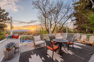 Deck at dusk with outdoor dining space and a patio