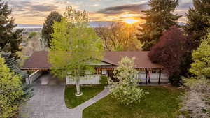 View from above of property featuring a tree filled landscape and mountains