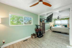 Bedroom with wood tiled floors and ceiling fan