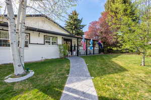 View of front of home featuring brick siding and a front yard