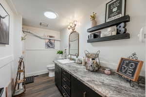 Full bathroom featuring vanity and dark wood finished floors