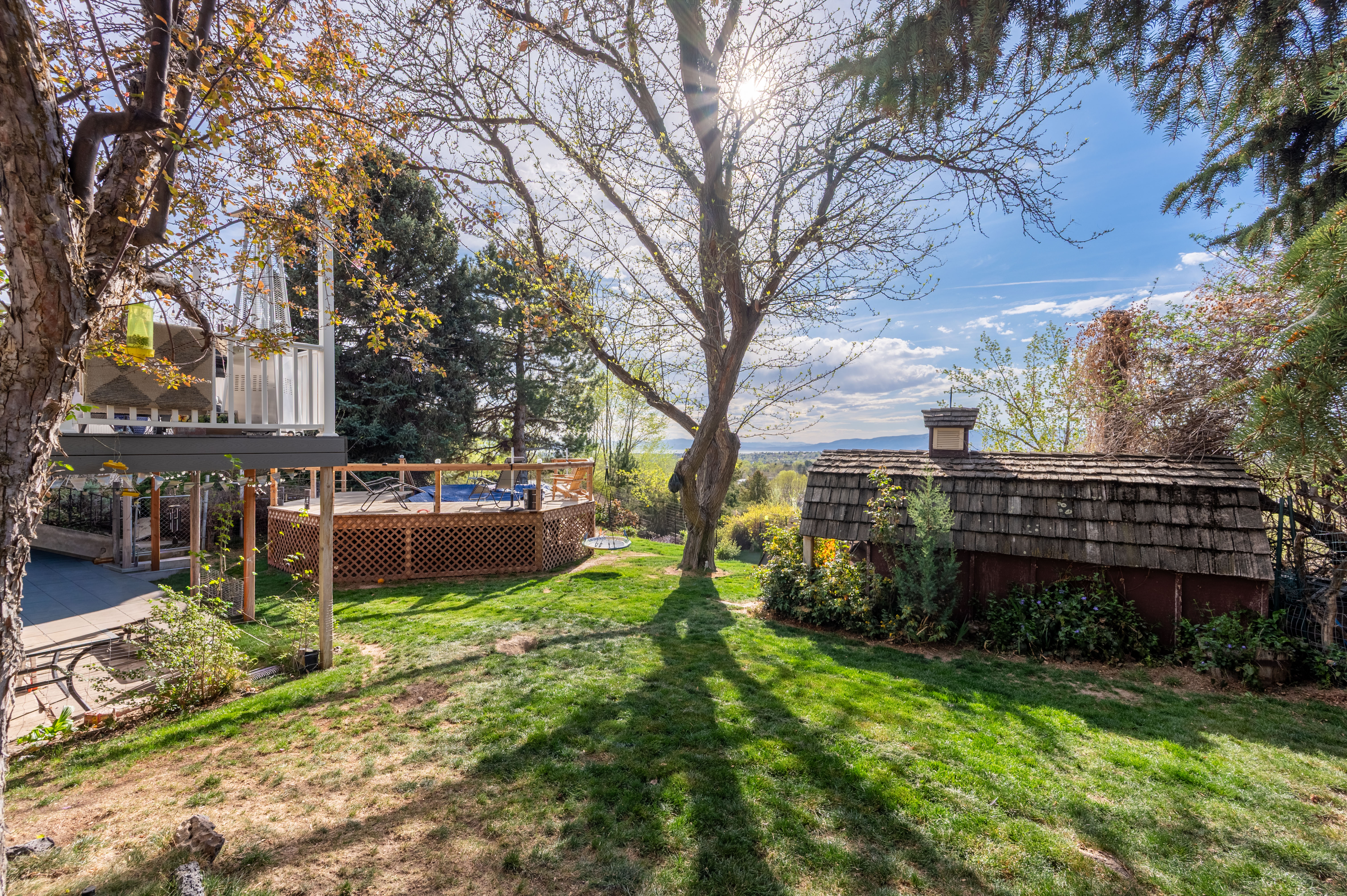 View of grassy yard featuring a deck