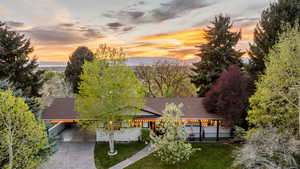 Aerial view at dusk of a mountain view and view of wooded area