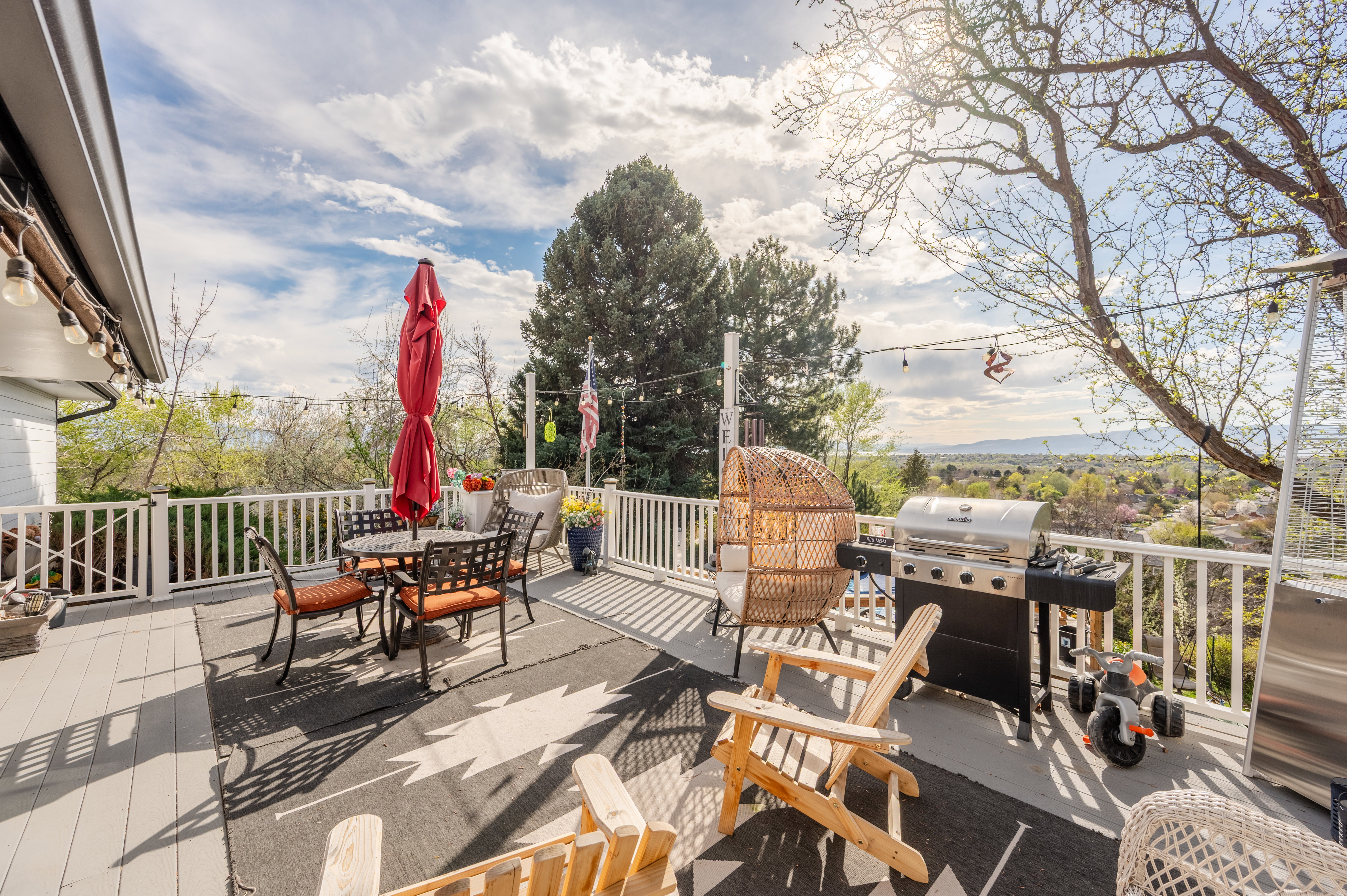 Wooden deck featuring grilling area and outdoor dining space