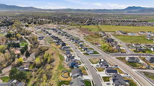 Aerial view of property's location featuring a mountainous background and nearby suburban area