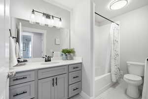 Full bathroom featuring vanity and shower / bathtub combination with curtain