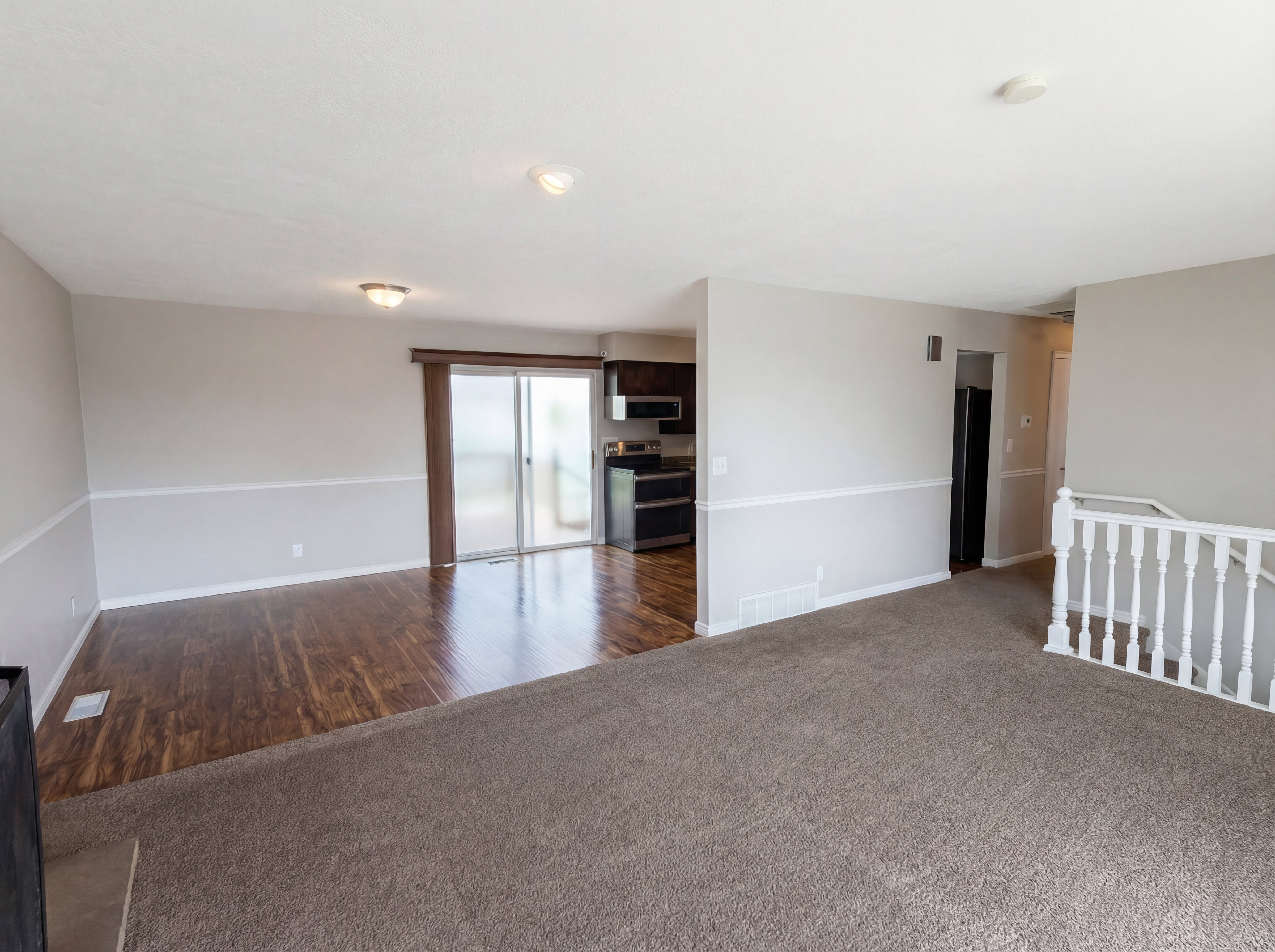 Spare room featuring dark carpet